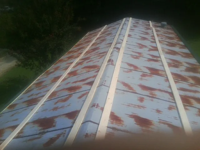 Rusted metal roof panels with new wood purlins before replacement — Storm Damage Roof Repair in Owensboro by Roofing Brothers