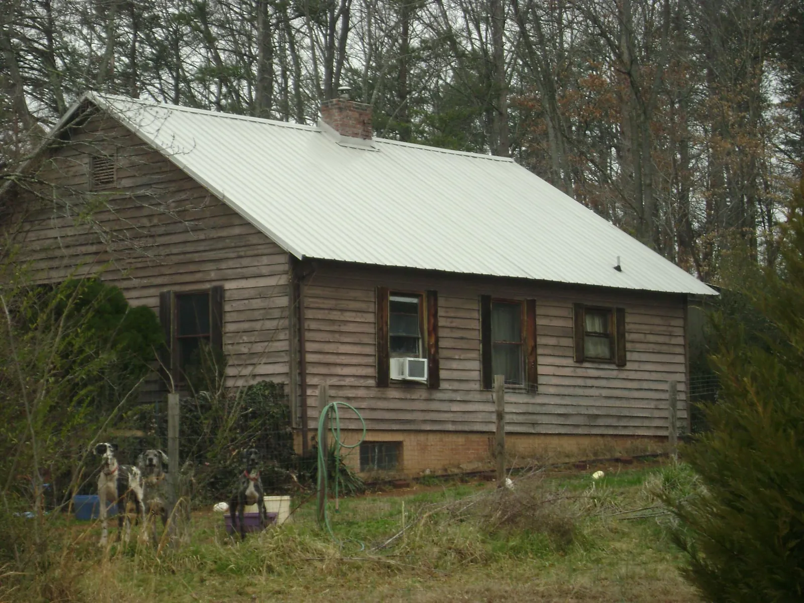 White metal roof on an old wood sided farmhouse, from a Metal Roof Installation job in Owensboro